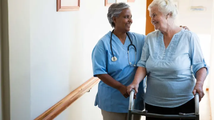 nurse assisting elderly woman